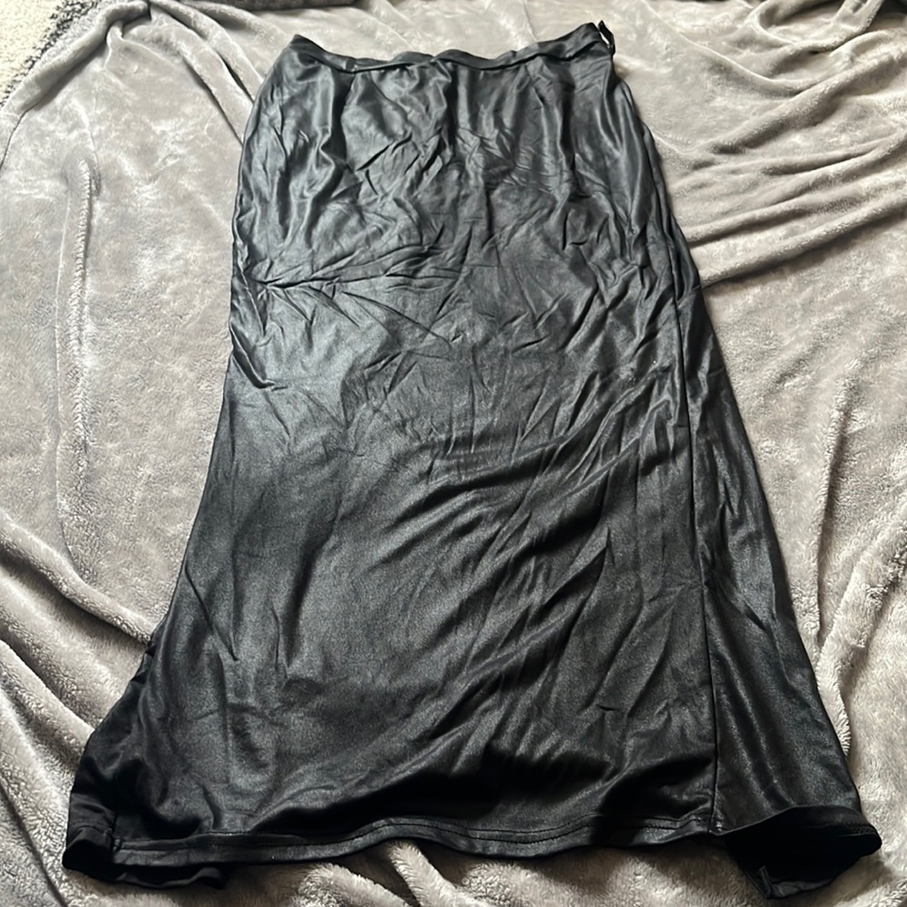 Form fitting black skirt with large slit